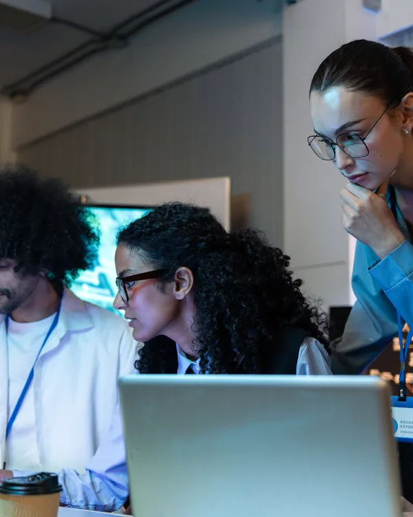 A team working on laptops at night